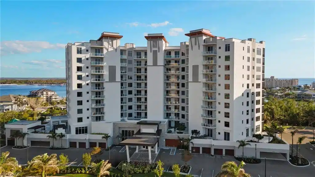 Image 1: Waterfront building exterior showcasing modern coastal architecture and sweeping bay views.