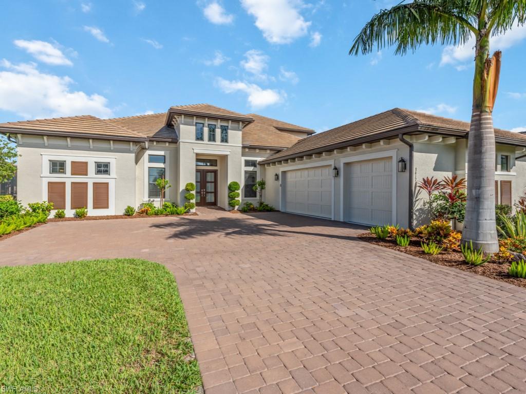 Image 1: Prairie-style house featuring decorative driveway, stucco siding, a garage, french doors, and a tiled roof