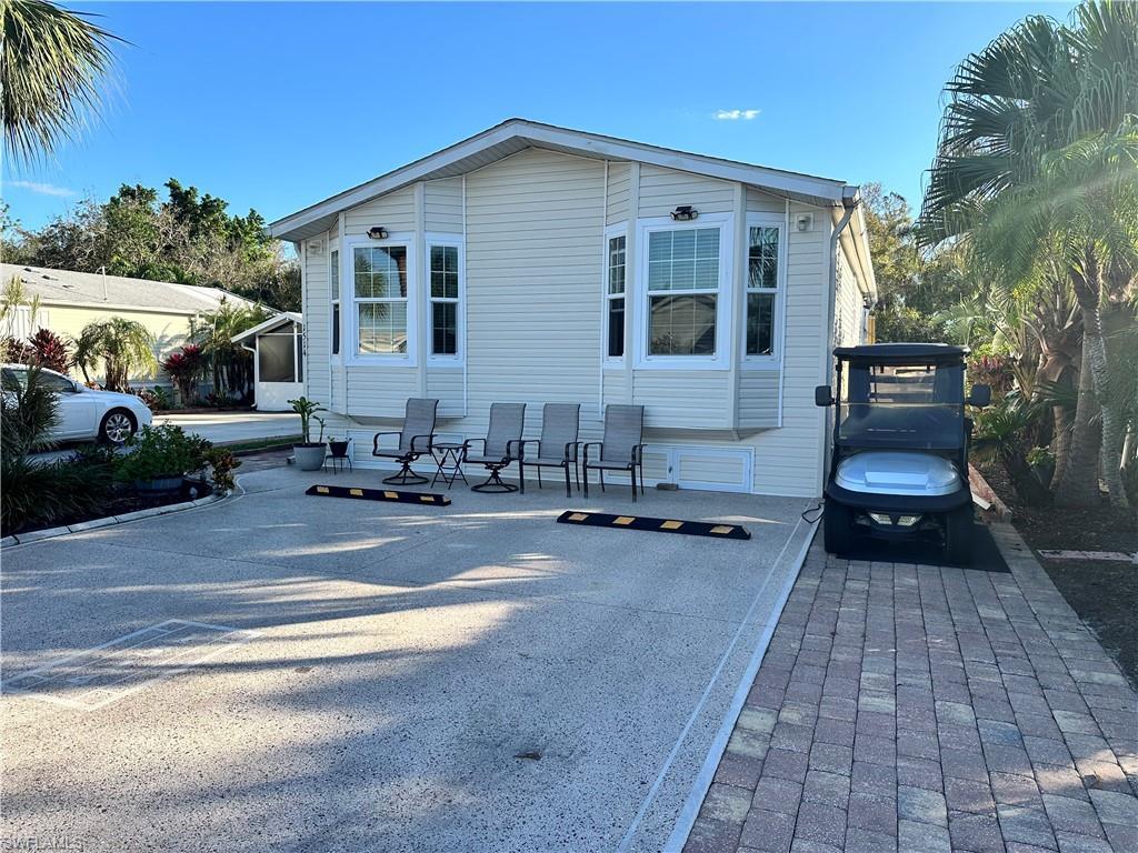 Image 1: View of front of house with a patio area