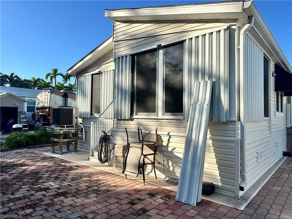 Image 4: View of property exterior with a central AC unit