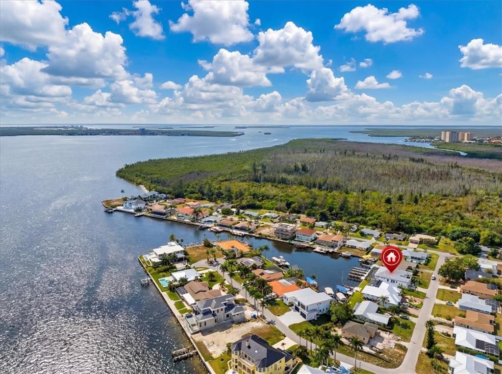 Image 2: Aerial perspective of suburban area with a large body of water