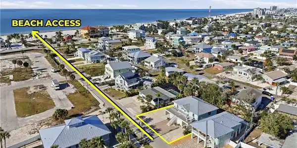 Image 2: Aerial view of property and surrounding area with a nearby body of water - Virtually Edited Image