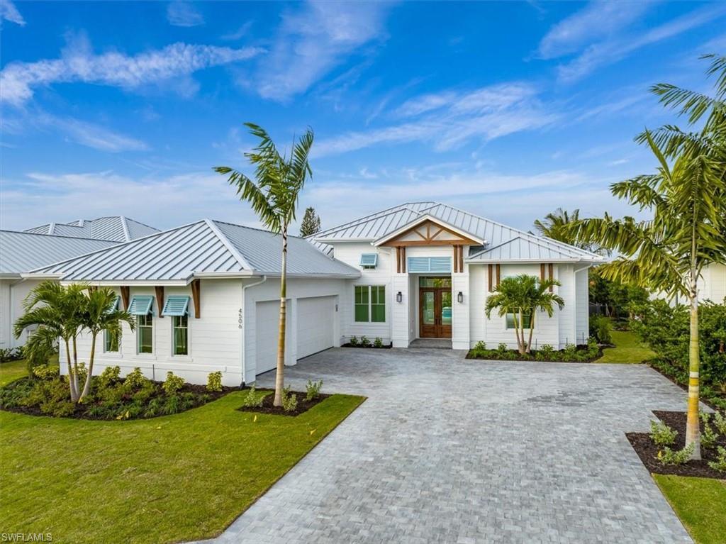 Image 1: Coconut Landing homes feature a coastalcontemporary vibe, with standing seam metalroofing, colorful bahama shutters, anddecorative wood accents.