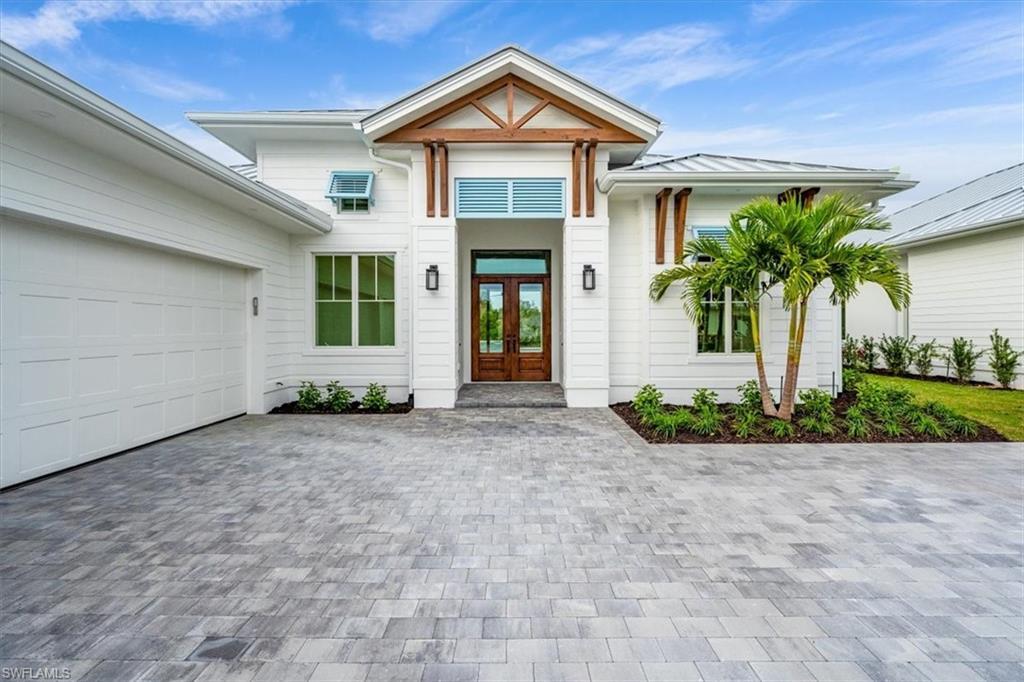 Image 2: Coconut Landing homes feature a coastalcontemporary vibe, with standing seam metalroofing, colorful bahama shutters, anddecorative wood accents.