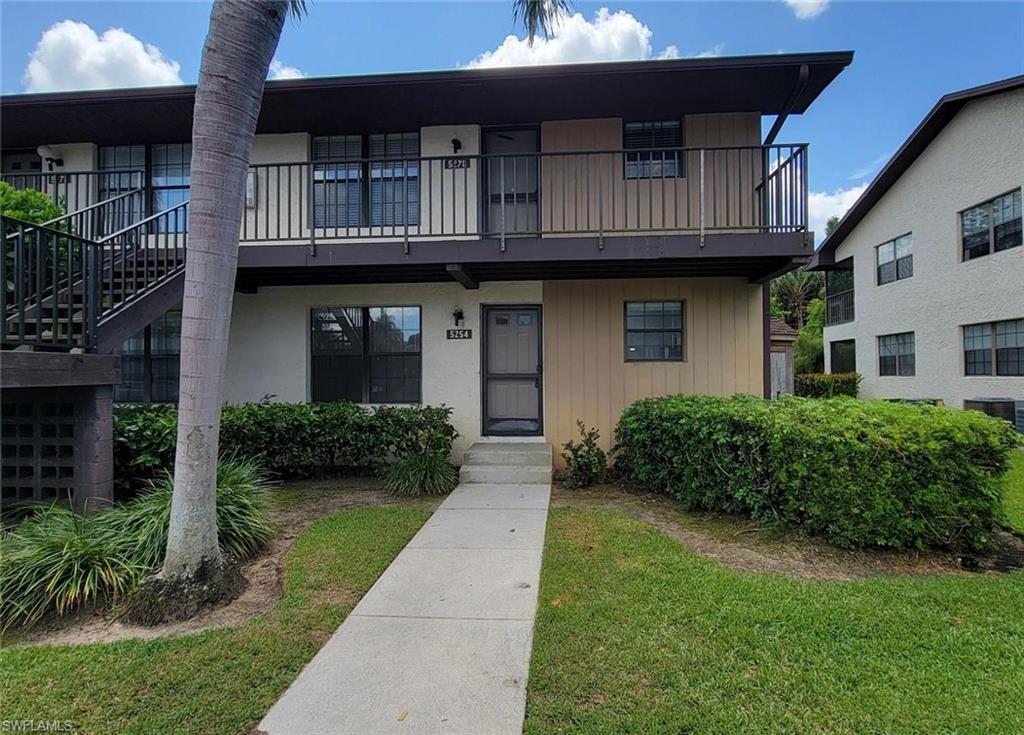 Image 1: View of front facade with a front lawn