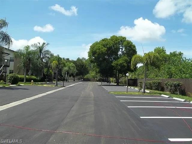 Image 2: View of asphalt road featuring street lights