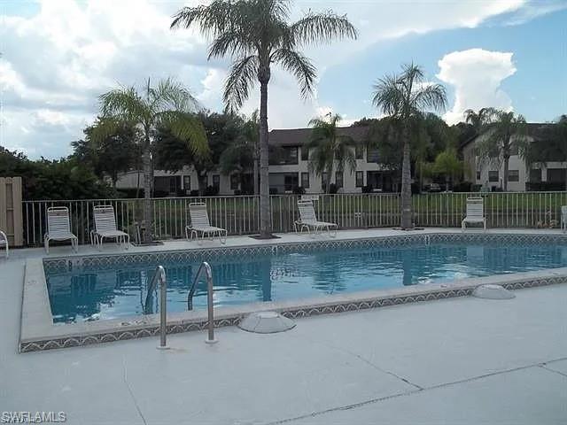 Image 3: Community pool with a patio