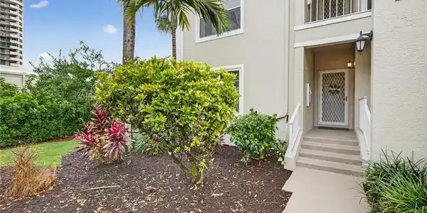 Image 2: Property entrance featuring stucco siding