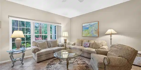 Image 3: Living area with ceiling fan and baseboards