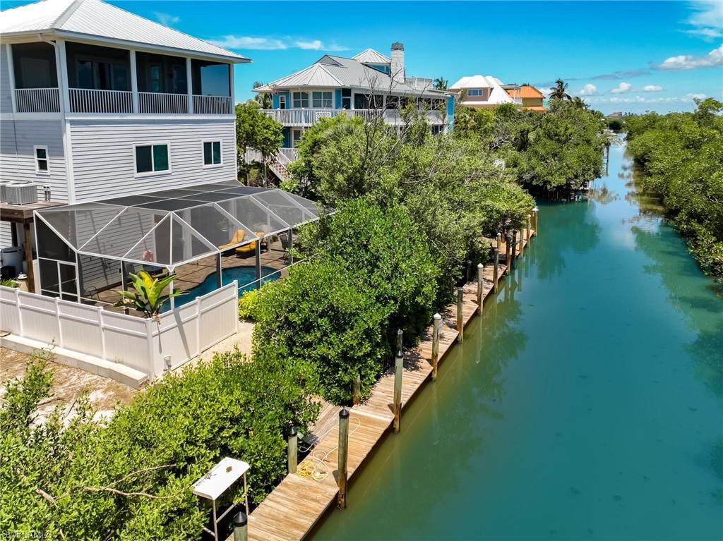 Image 3: Rear view of property with a carport, a patio, and a balcony