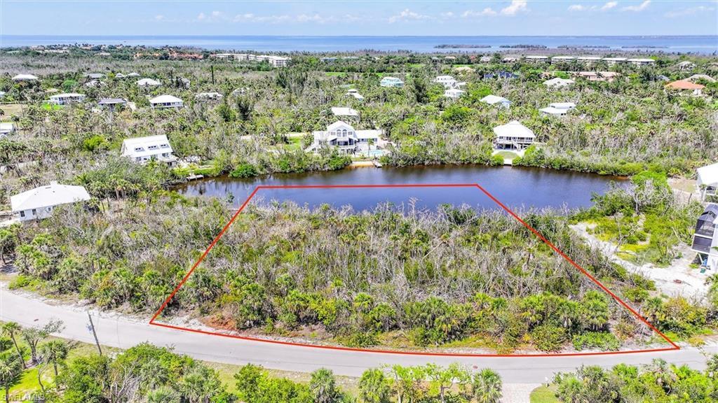 Image 3: Aerial view of residential area featuring a large body of water