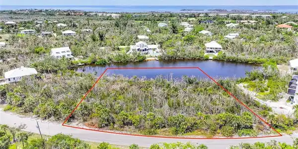Image 3: Aerial view of residential area featuring a large body of water
