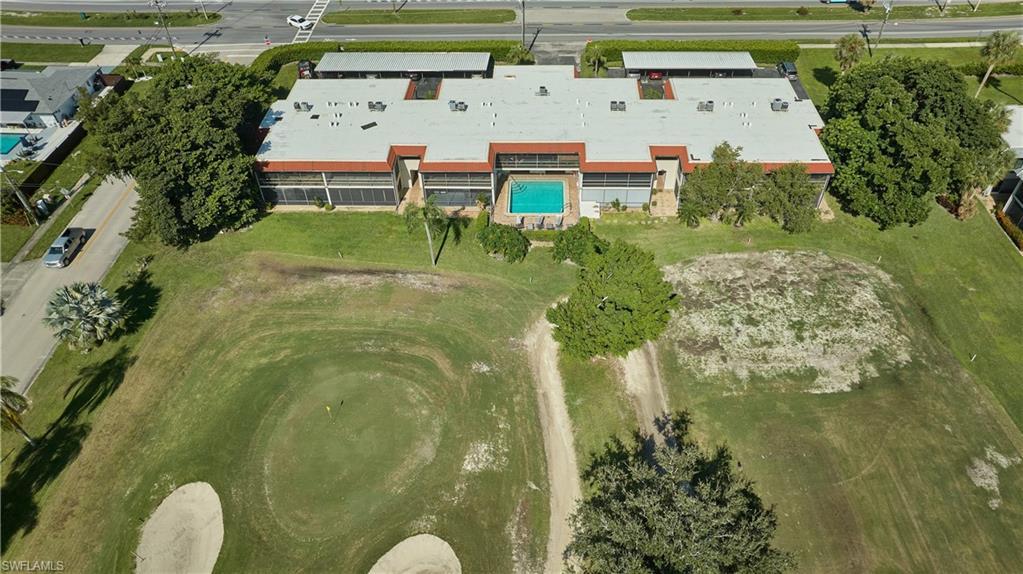Image 2: Aerial overview of property's location with a pool