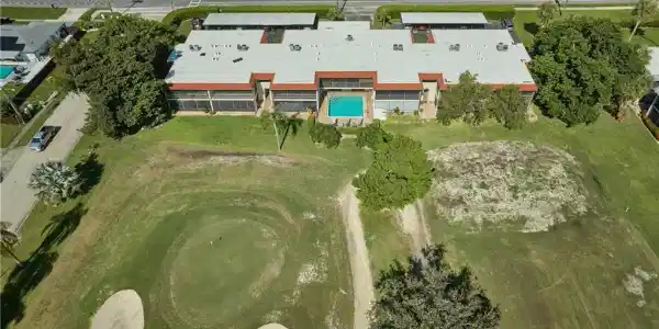 Image 2: Aerial overview of property's location with a pool