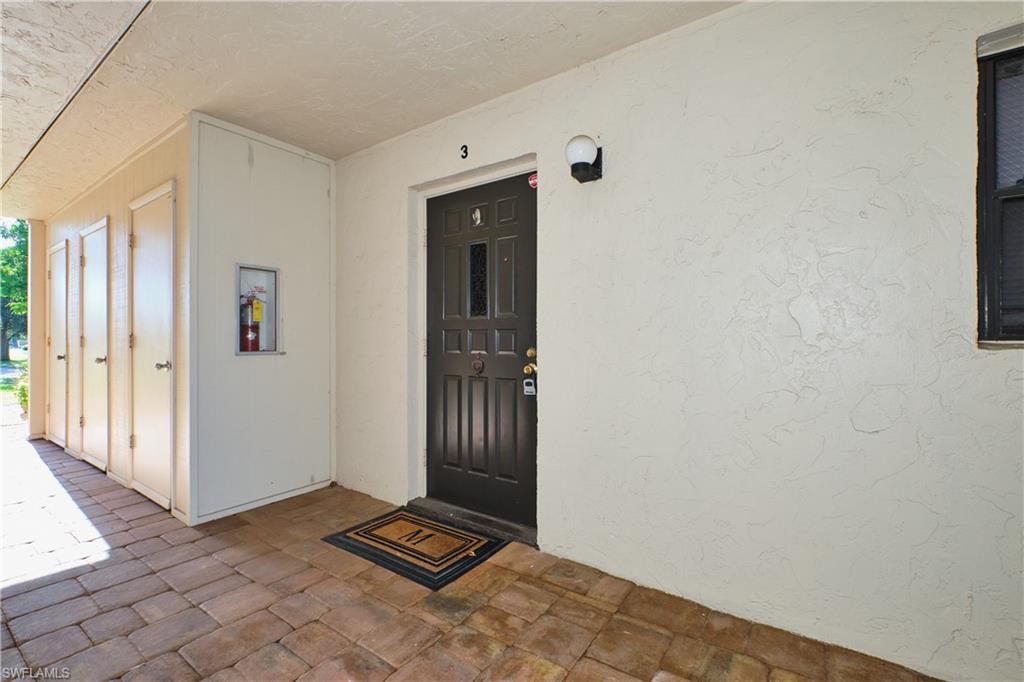 Image 3: Doorway to property with stucco siding