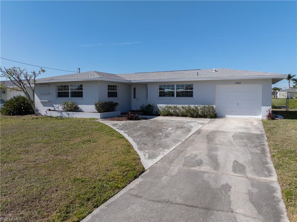 Image 2: Single story home with a garage and a front yard