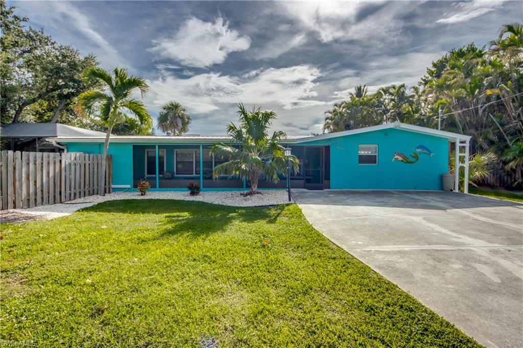 Image 1: Ranch-style home with concrete driveway