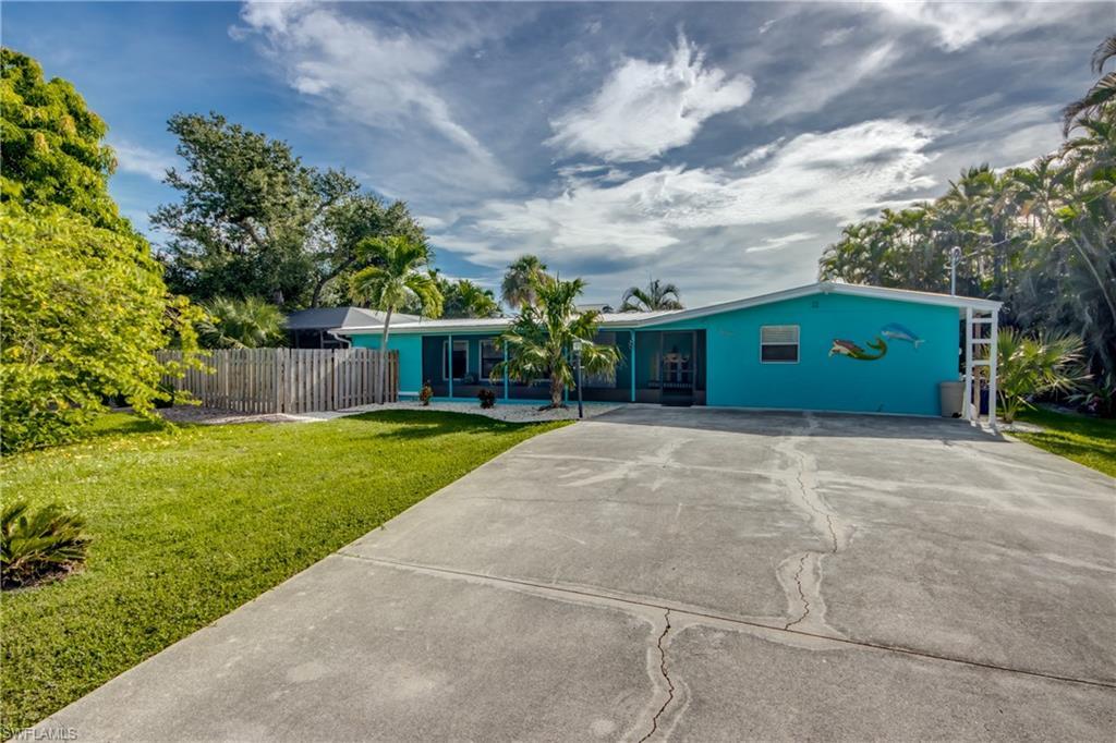 Image 2: Ranch-style home with concrete driveway