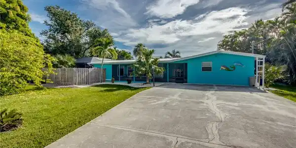 Image 2: Ranch-style home with concrete driveway