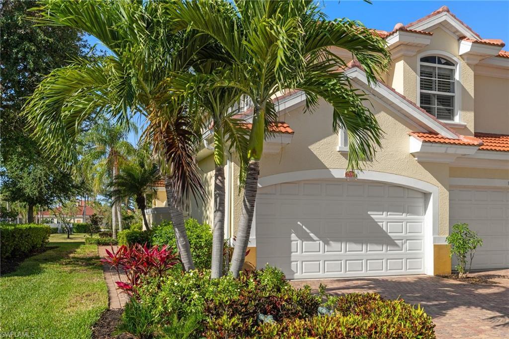 Image 1: View of home's exterior with stucco siding, a tiled roof, 2 car garage and driveway