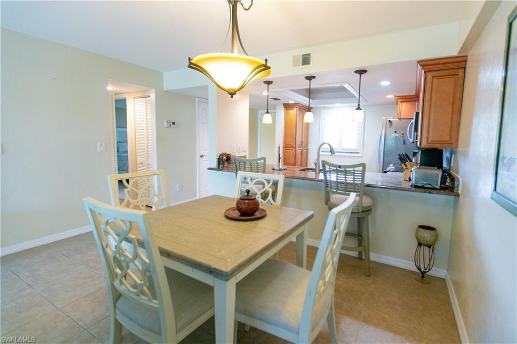 Image 4: Dining room featuring light tile patterned floors and recessed lighting