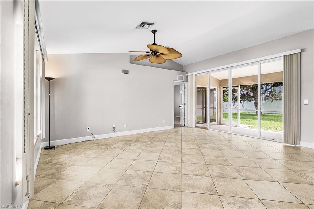 Image 3: Spare room featuring vaulted ceiling, ceiling fan, and light tile patterned flooring