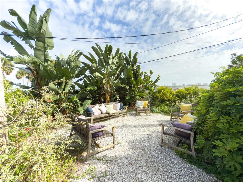 Image 4: Back of house with a chimney and brick siding