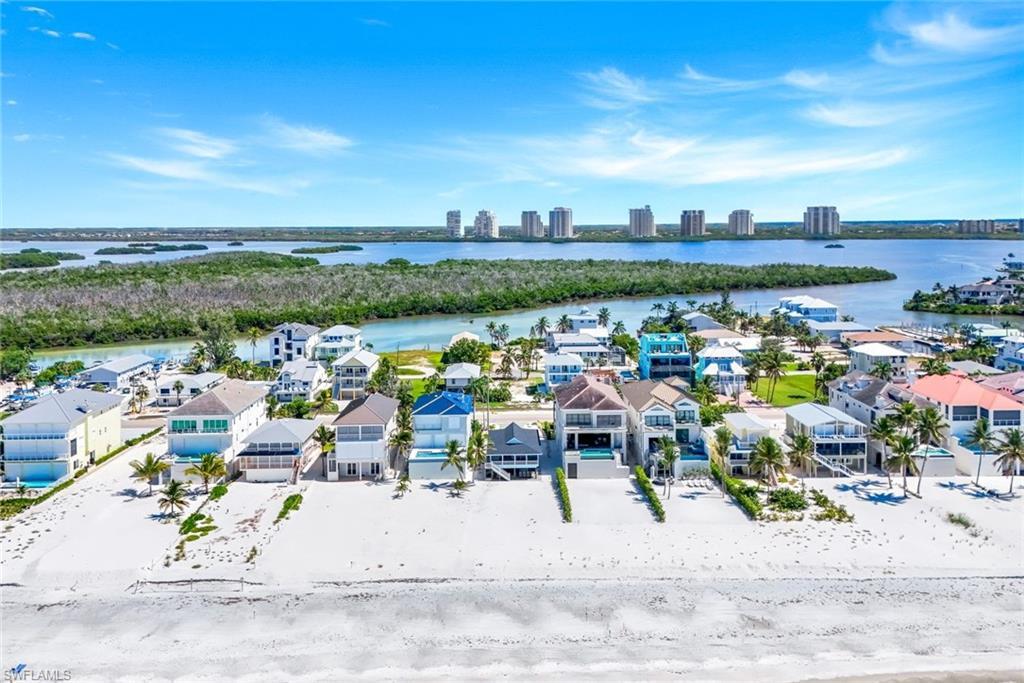 Image 4: Aerial perspective of suburban area featuring a nearby body of water