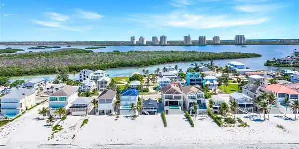 Image 4: Aerial perspective of suburban area featuring a nearby body of water