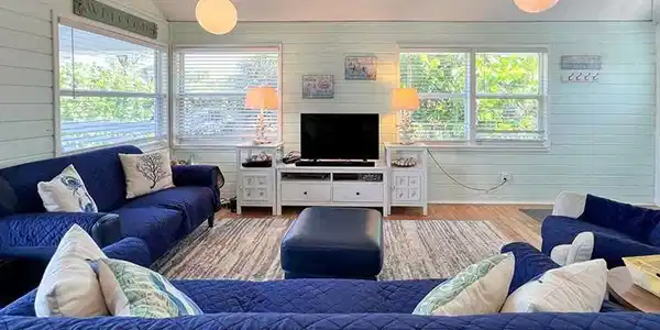 Image 4: Living room with vaulted ceiling and hardwood / wood-style floors