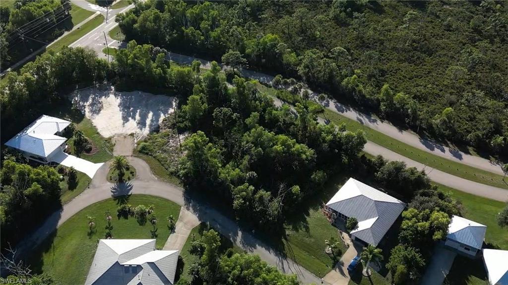 Image 2: Aerial view of property and surrounding area featuring a forest