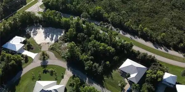 Image 2: Aerial view of property and surrounding area featuring a forest