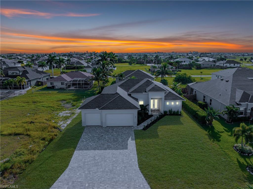 Image 2: Aerial view at dusk of a residential view