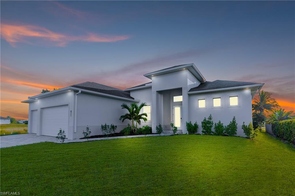 Image 4: Modern home featuring a front yard, stucco siding, concrete driveway, and an attached garage