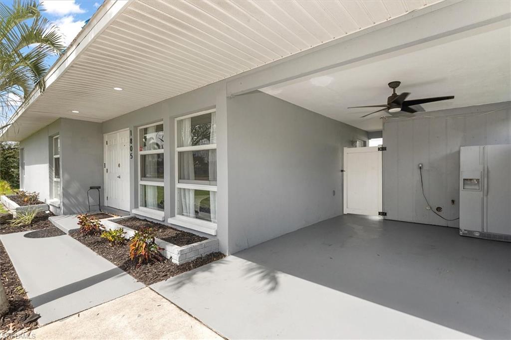 Image 3: Single story home featuring concrete driveway, stucco siding, an attached carport, and ceiling fan