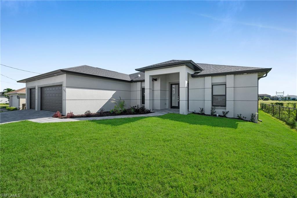 Image 3: Prairie-style home with an attached garage, roof with shingles, stucco siding, and driveway