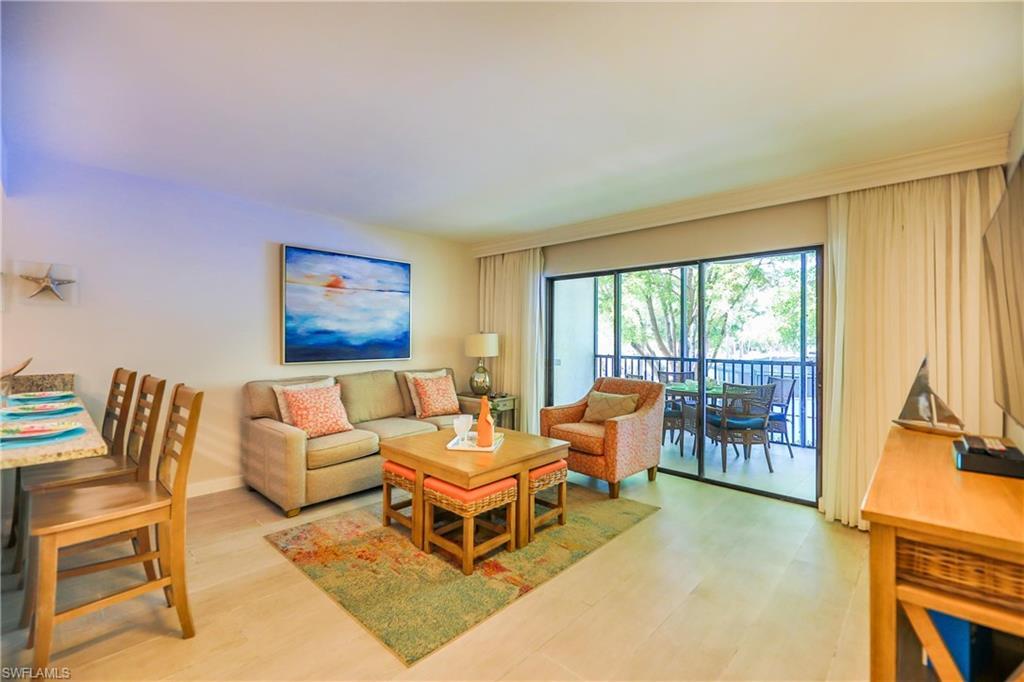 Image 1: Living area featuring light wood-type flooring and baseboards