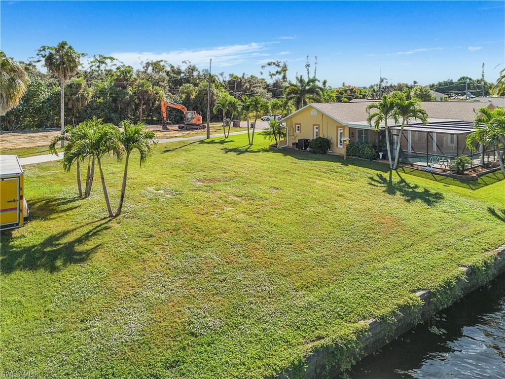 Image 4: Aerial overview of property's location featuring a large body of water and property parcel outlined