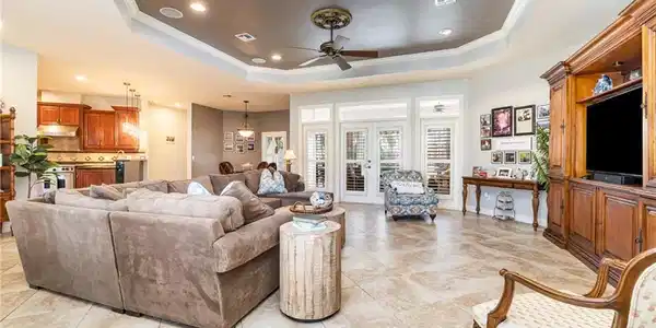 Image 2: Living area featuring recessed lighting, ceiling fan, a raised ceiling, ornamental molding, and light tile patterned floors