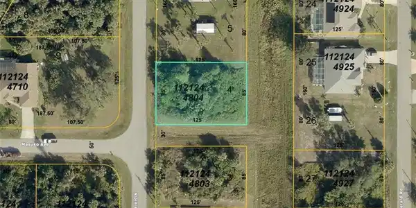 Image 2: Aerial view of property's location featuring property parcel outlined