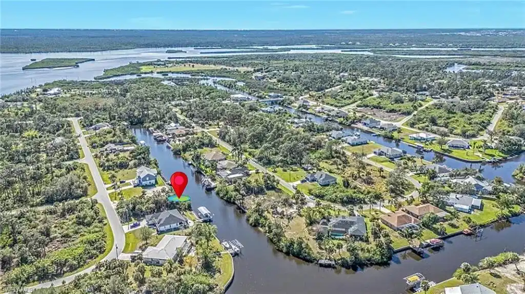 Image 1: Aerial overview of property's location featuring a large body of water