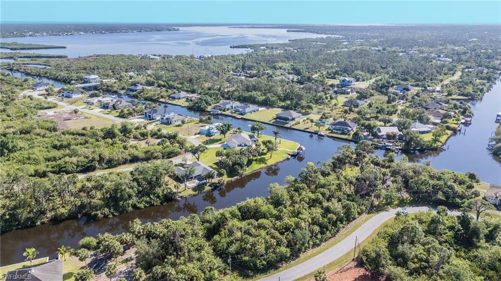 Image 2: Aerial view of property's location featuring a nearby body of water