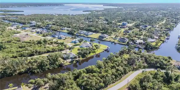 Image 2: Aerial view of property's location featuring a nearby body of water