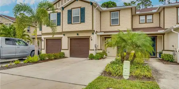 Image 2: Craftsman-style house with driveway and a garage