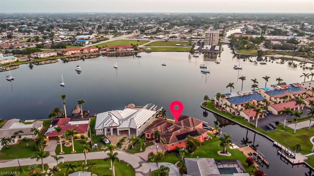 Image 4: Aerial perspective of suburban area featuring a large body of water
