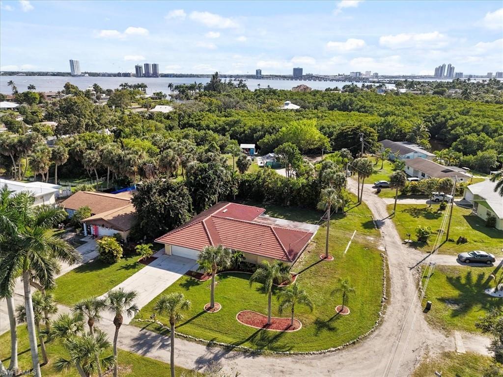 Image 1: Drone / aerial view of city skyline and a nearby body of water