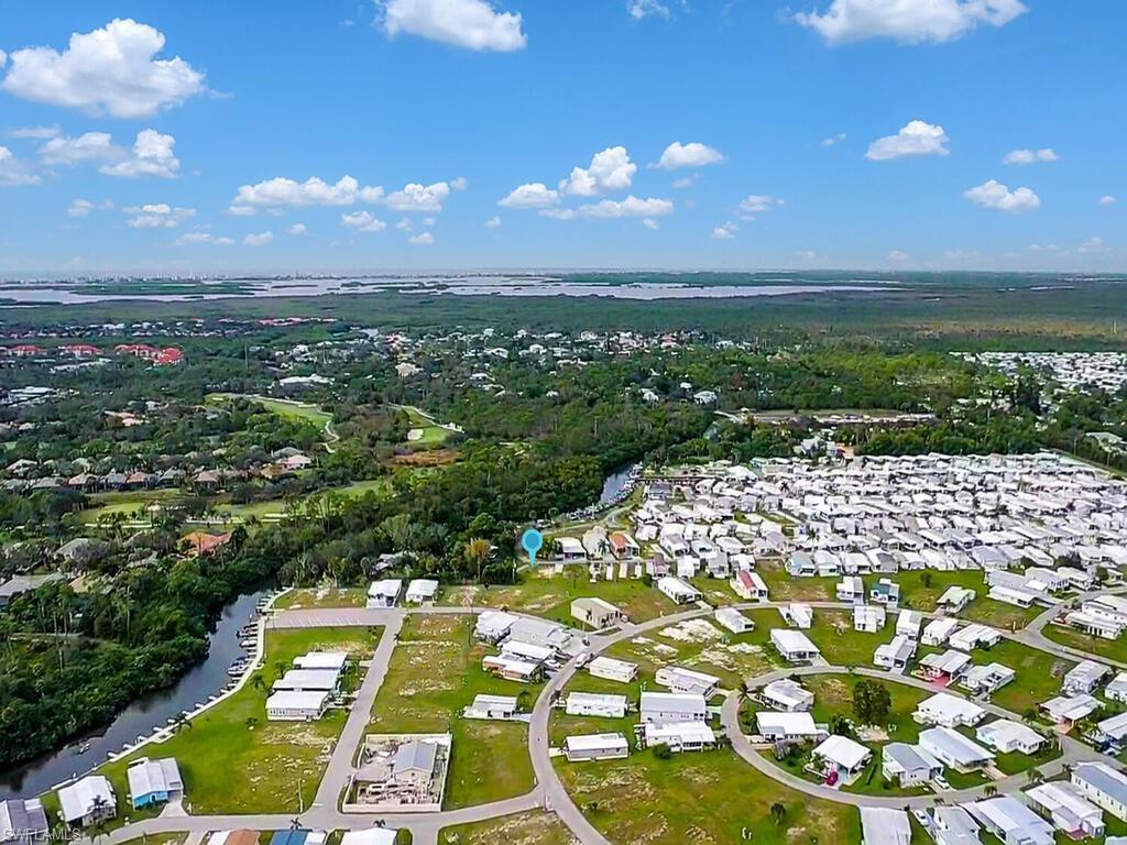 Image 3: View of property location with nearby suburban area and a large body of water