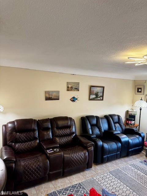 Image 4: Living room with a ceiling fan and a textured ceiling
