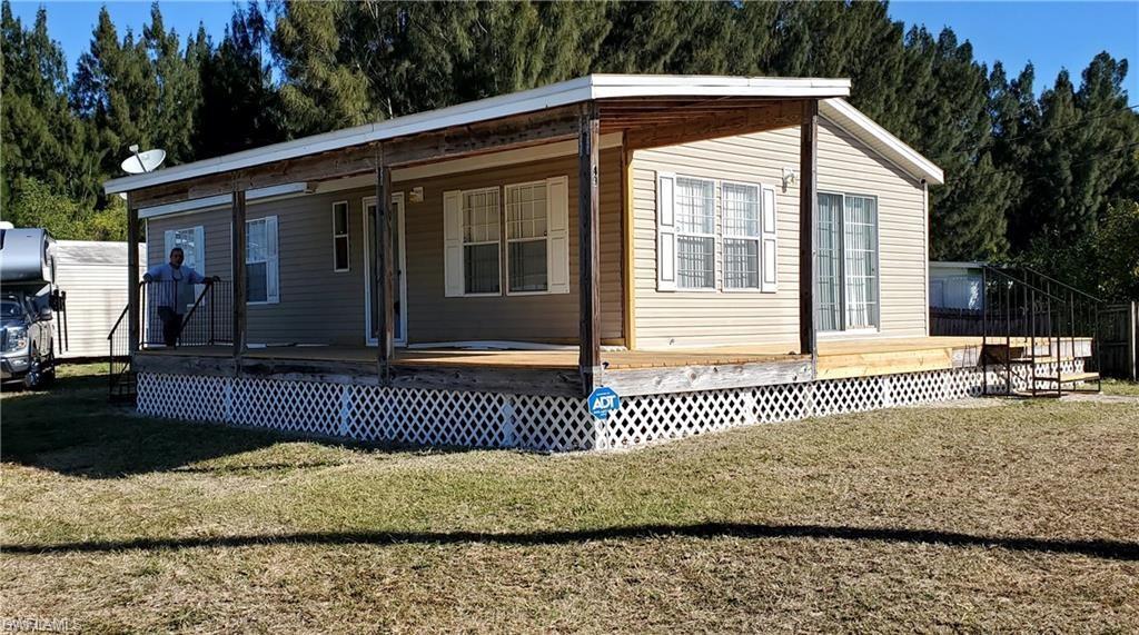 Image 1: Rear view of house featuring a lawn and a porch