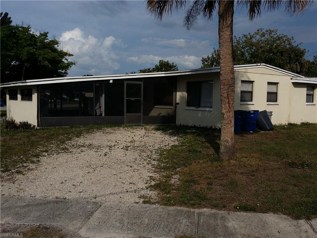 Image 1: View of front of house featuring a sunroom and stucco siding